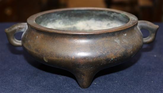 A Chinese brown patinated bronze ding censer, Xuande six character mark, probably 17th/18th century, width 21cm